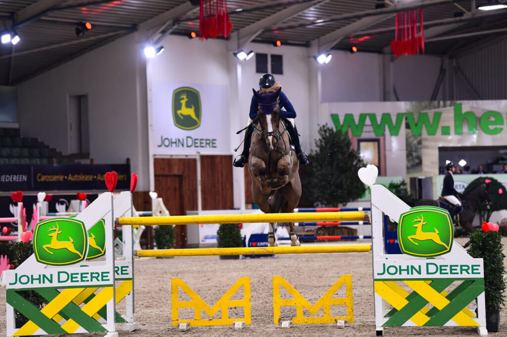 Show Jumper Quinton with Emilie Stampfli jumping over obstacle